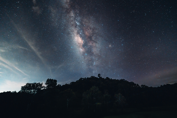 night sky full of stars over a landscape