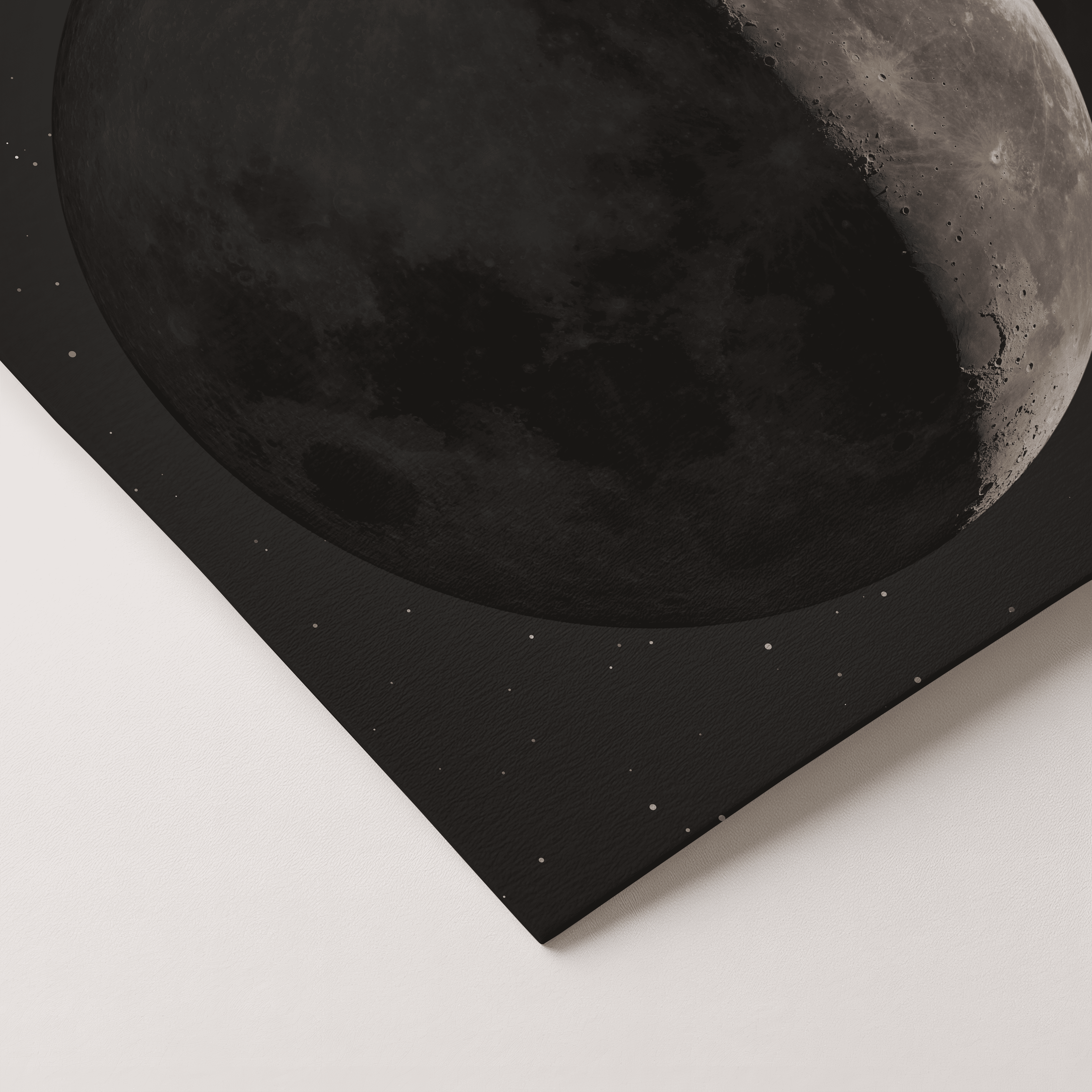 A square black canvas print featuring a close-up artistic depiction of the moon, shown at an angle on a light gray background.